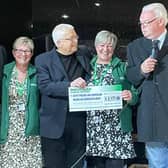 Macmillan nurses receiving cheque from Absent Friends event