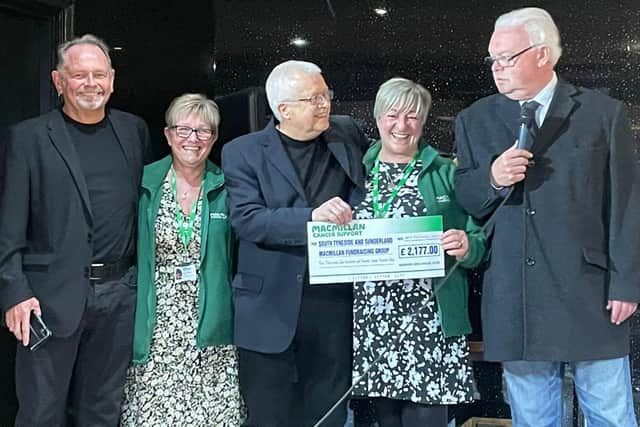 Macmillan nurses receiving cheque from Absent Friends event
