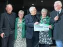 Macmillan nurses receiving cheque from Absent Friends event