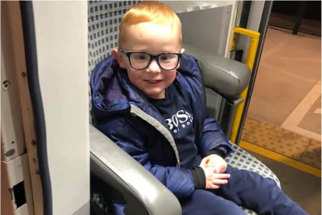 Harrison sitting in the cabin of the Tyne and Wear metro