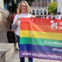 Adoption Matters parading their LGBTQ+ Pride flag.