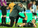 Newcastle United's Scottish midfielder Ryan Fraser (R) is treated for an injury during the English Premier League football match between Newcastle United and Wolverhampton Wanderers at St James' Park in Newcastle-upon-Tyne, north east England on April 8, 2022. (Photo by LINDSEY PARNABY/AFP via Getty Images)