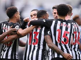 Callum Wilson is mobbed by his team-mates.