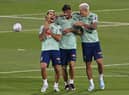 Brazil's midfielders Bruno Guimaraes (L) and Lucas Paqueta and forward Pedro laugh during a training session at the Al Arabi SC Stadium in Doha on November 20, 2022, just moments before the kick-off of the Qatar 2022 World Cup football tournament. (Photo by NELSON ALMEIDA/AFP via Getty Images)