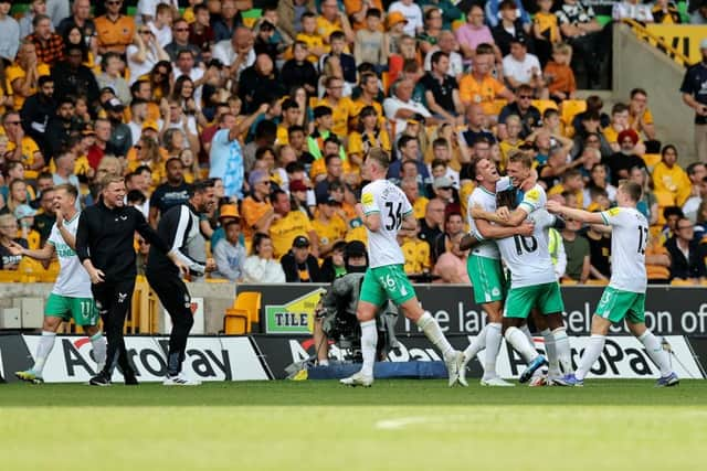 Allan Saint-Maximin of Newcastle United celebrates with team mates and manager, Eddie Howe after scoring their team's first goal  during the Premier League match between Wolverhampton Wanderers and Newcastle United at Molineux on August 28, 2022 in Wolverhampton, England. (Photo by David Rogers/Getty Images)