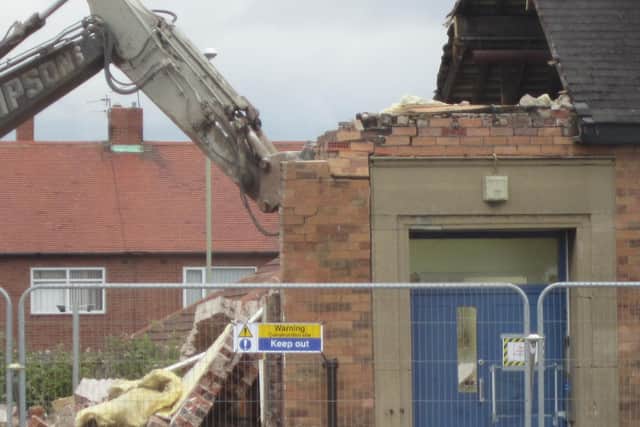 An image of the old school building being demolished