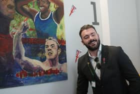 Josef Craig MBE in front of his artistic drawing by student