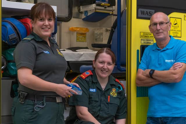 Paul Durham with NEAS clinical care assistant Emma Newton (left) and paramedic Rachael Hewitt (right).