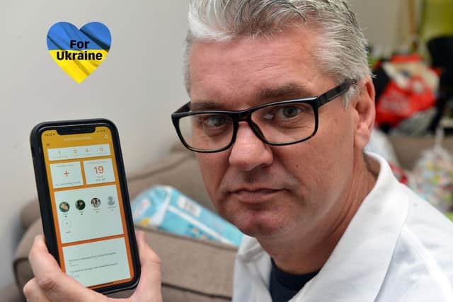 ExCommunicate Managing Director, Paul Briggs, with the company's newly adapted app to help displaced and separated families fleeing Ukraine to keep in touch.