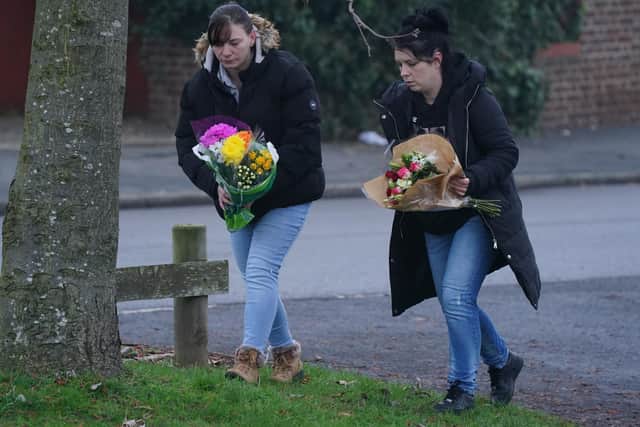 Members of the public lay flowers near to the scene