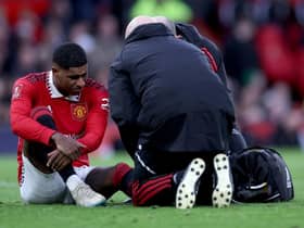 Marcus Rashford of Manchester United receives medical treatment during the Emirates FA Cup Quarter Final match between Manchester United and Fulham at Old Trafford on March 19, 2023 in Manchester, England. (Photo by Clive Brunskill/Getty Images)