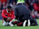 Marcus Rashford of Manchester United receives medical treatment during the Emirates FA Cup Quarter Final match between Manchester United and Fulham at Old Trafford on March 19, 2023 in Manchester, England. (Photo by Clive Brunskill/Getty Images)