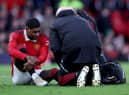 Marcus Rashford of Manchester United receives medical treatment during the Emirates FA Cup Quarter Final match between Manchester United and Fulham at Old Trafford on March 19, 2023 in Manchester, England. (Photo by Clive Brunskill/Getty Images)
