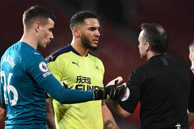 Karl Darlow and Jamaal Lascelles speak to referee Paul Tierney at Old Trafford.