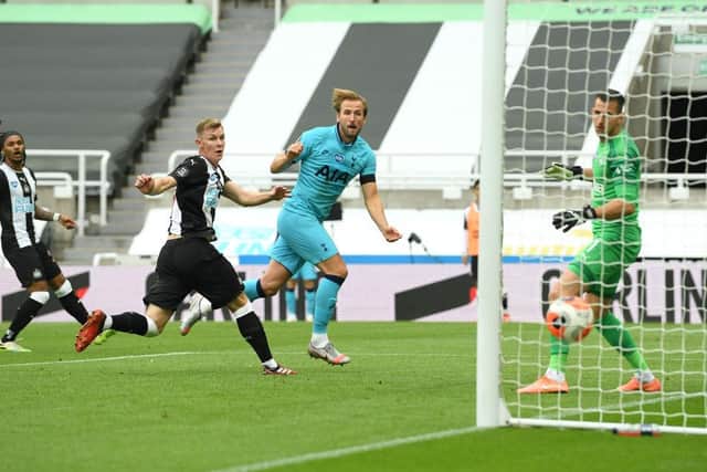 NEWCASTLE UPON TYNE, ENGLAND - JULY 15:  Tottenham Hotspur striker Harry Kane (C) heads past Newcastle United goalkeeper Martin Dubravka and defender Emil Krafth (2nd R) to score their second goal during the Premier League match between Newcastle United and Tottenham Hotspur at St. James Park.