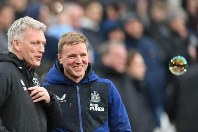 Newcastle United's English head coach Eddie Howe (L) speaks with Newcastle United's English head coach Eddie Howe during the English Premier League football match between West Ham and Newcastle United at the London Stadium, in London on February 19, 2022. (Photo by JUSTIN TALLIS/AFP via Getty Images)