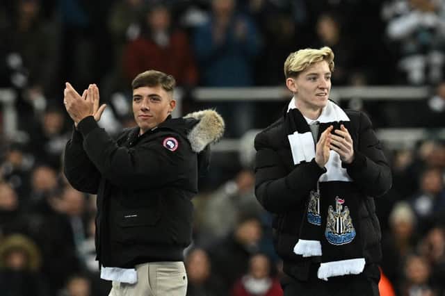 Newcastle United's new recruit Scottish defender Harrison Ashby (L) and English forward Anthony Gordon (R) applaud the fans prior to the start of the English League Cup semi final football match between Newcastle United and Southampton at St James's Park stadium in Newcastle, on January 31, 2023.  (Photo by PAUL ELLIS/AFP via Getty Images)