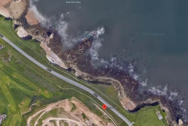 An aerial view looking down on the Coast Road and cliffs