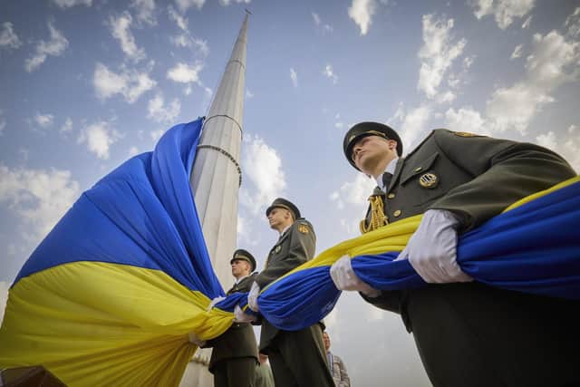Honour guard soldiers prepare to rise the Ukrainian national flag during State Flag Day celebrations in Kyiv, Ukraine, Tuesday, Aug. 23, 2022. (Ukrainian Presidential Press Office via AP)