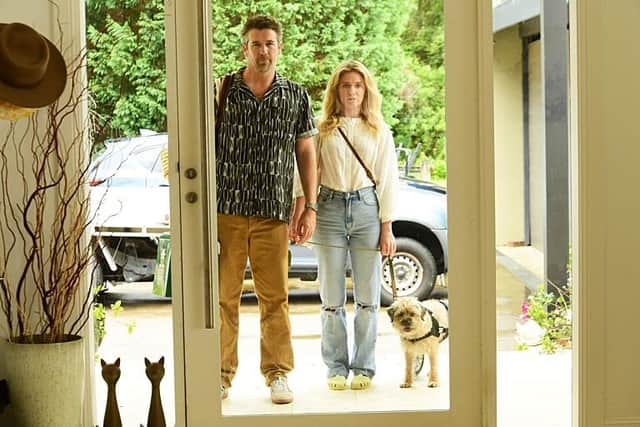 Gordon (Patrick Brammall) and Ashley (Harriet Dyer) with the canine star of the Aussie sitcom Colin From Accounts (Picture: BBC/CBS Studios/Paramount+ ©2024/Tony Mott)