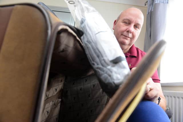 Gary Elliott, 57, packing his suitcase after finally learning he can travel to Canada to pay his respects to his deceased brother.