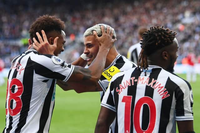 Newcastle United goalscorer Joe Willock celebrates with team-mate Bruno Guimaraes.
