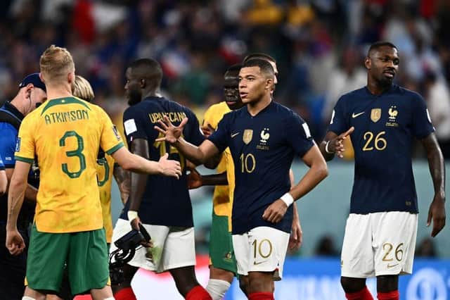 France's forward #10 Kylian Mbappe (C) shakes hands with Australia's midfielder #03 Nathaniel Atkinson at the end of the Qatar 2022 World Cup Group D football match between France and Australia at the Al-Janoub Stadium in Al-Wakrah, south of Doha on November 22, 2022. (Photo by JEWEL SAMAD/AFP via Getty Images)