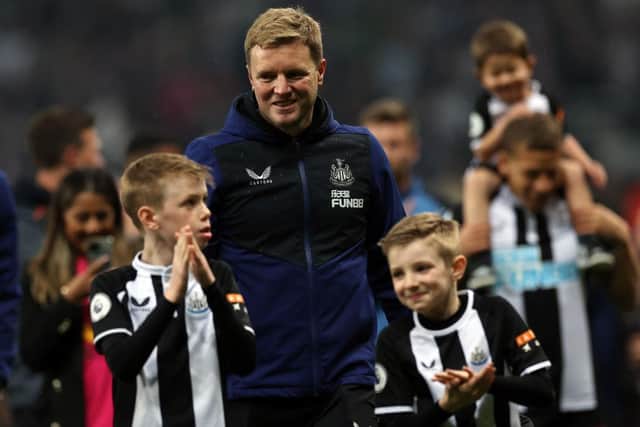 Newcastle United head coach Eddie Howe on the pitch with his sons after May's win over Arsenal.