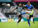 Callum Wilson of Newcastle United is challenged by Adam Webster of Brighton and Hove Albion  (Photo by Alex Pantling/Getty Images)