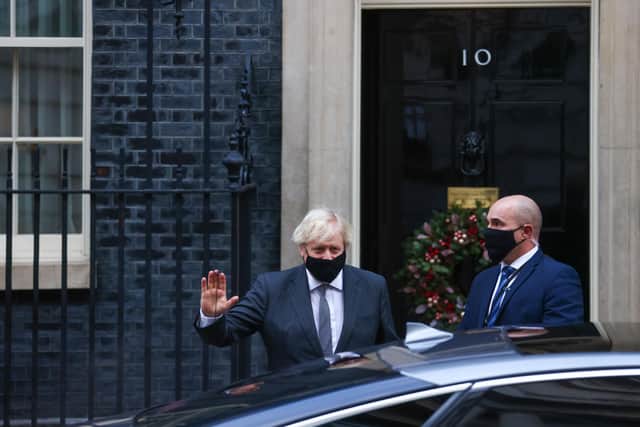 Boris Johnson, U.K. prime minster, departs from number 10 Downing Street to attend a vote in Parliament in London, U.K., on Wednesday, Dec. 30, 2020.