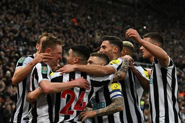 Sean Longstaff, left, is mobbed by his Newcastle United team-mates after scoring his second goal.