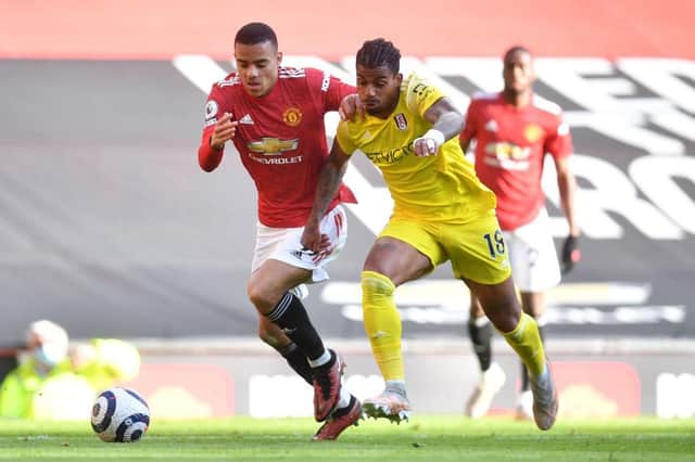 Fulham's Gabonese midfielder Mario Lemina (R) vies for the ball against Manchester United's English striker Mason Greenwood (L) during the English Premier League football match between Manchester United and Fulham at Old Trafford in Manchester, north west England, on May 18, 2021.