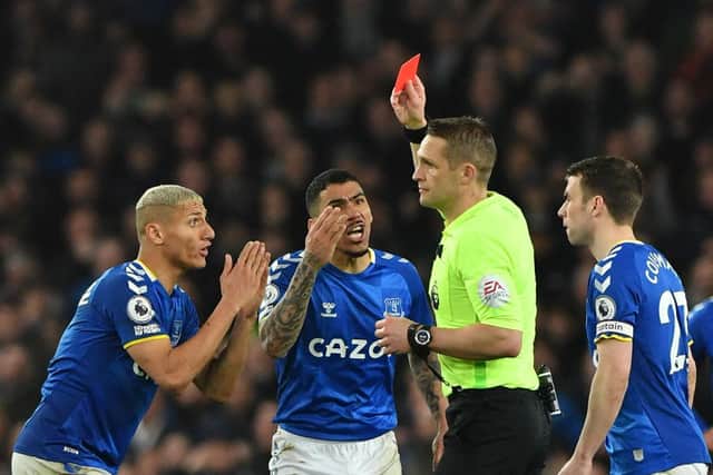English referee Craig Pawson shows a red card to Everton's Brazilian midfielder Allan (C) during the English Premier League football match between Everton and Newcastle United at Goodison Park in Liverpool, north west England on March 17, 2022. (Photo by ANTHONY DEVLIN/AFP via Getty Images)