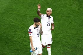 Christian Pulisic (L) and Deandre Yedlin of United States react after the 1-1 draw during the FIFA World Cup Qatar 2022 Group B match between USA and Wales at Ahmad Bin Ali Stadium on November 21, 2022 in Doha, Qatar. (Photo by Tim Nwachukwu/Getty Images)