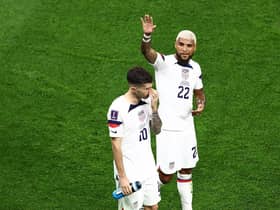 Christian Pulisic (L) and Deandre Yedlin of United States react after the 1-1 draw during the FIFA World Cup Qatar 2022 Group B match between USA and Wales at Ahmad Bin Ali Stadium on November 21, 2022 in Doha, Qatar. (Photo by Tim Nwachukwu/Getty Images)