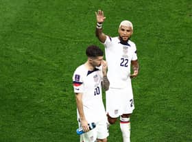 Christian Pulisic (L) and Deandre Yedlin of United States react after the 1-1 draw during the FIFA World Cup Qatar 2022 Group B match between USA and Wales at Ahmad Bin Ali Stadium on November 21, 2022 in Doha, Qatar. (Photo by Tim Nwachukwu/Getty Images)