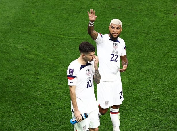 Christian Pulisic (L) and Deandre Yedlin of United States react after the 1-1 draw during the FIFA World Cup Qatar 2022 Group B match between USA and Wales at Ahmad Bin Ali Stadium on November 21, 2022 in Doha, Qatar. (Photo by Tim Nwachukwu/Getty Images)