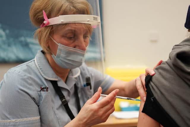 A patient receives the Pfizer BioNTech Covid-19 vaccine at a mass vaccination hub at the Centre For Life in Newcastle. Picture: PA.