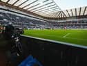 A TV camera films the action during a Premier League match at St James's Park.