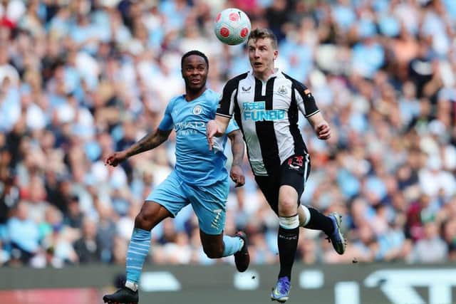 Raheem Sterling of Manchester City challenges Matt Targett of Newcastle United during the Premier League match between Manchester City and Newcastle United at Etihad Stadium on May 08, 2022 in Manchester, England. (Photo by Alex Livesey/Getty Images)