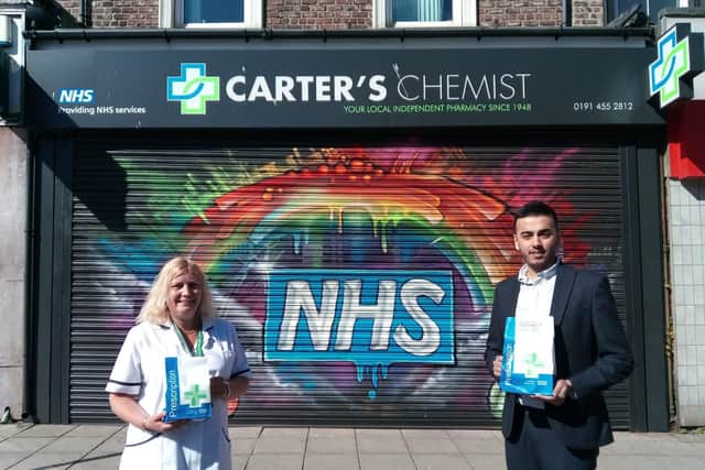 Carter's Pharmacy Owner Hassan Malik and dispensing staff Deborah Garthwaite in front of the Fowler Street shop after its repaint in support of the NHS.