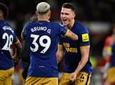Newcastle United defender Sven Botman celebrates with midfielder Bruno Guimaraes.