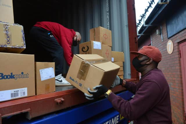 Book Aid For Africa workers loading the container to head out to Nigeria.