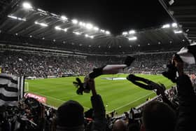 Newcastle United fans wave their scarves before the second leg of the club's Carabao Cup semi-final against Southampton.