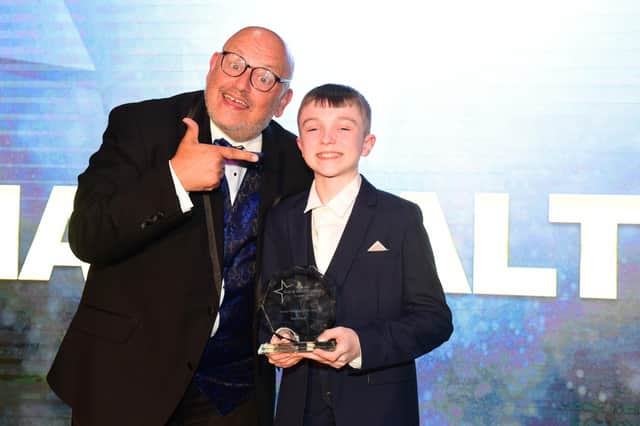 Young Performer of the Year Award winner Max Walton receives his award from Ray Spencer .