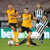 WOLVERHAMPTON, ENGLAND - OCTOBER 25: Daniel Podence of Wolverhampton Wanderers is tackled by Fabian Schar of Newcastle United during the Premier League match between Wolverhampton Wanderers and Newcastle United at Molineux on October 25, 2020 in Wolverhampton, England. Sporting stadiums around the UK remain under strict restrictions due to the Coronavirus Pandemic as Government social distancing laws prohibit fans inside venues resulting in games being played behind closed doors. (Photo by Nick Potts - Pool/Getty Images)