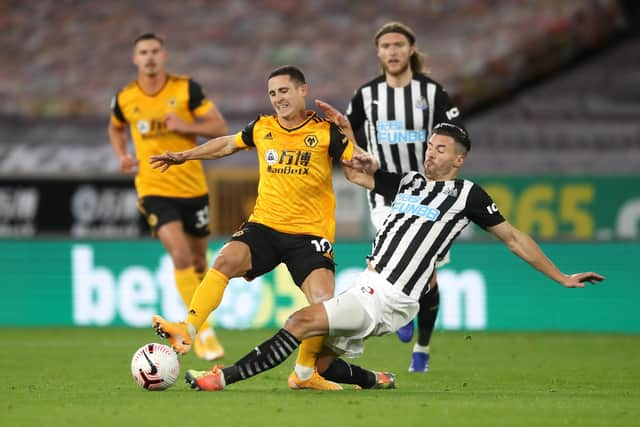 WOLVERHAMPTON, ENGLAND - OCTOBER 25: Daniel Podence of Wolverhampton Wanderers is tackled by Fabian Schar of Newcastle United during the Premier League match between Wolverhampton Wanderers and Newcastle United at Molineux on October 25, 2020 in Wolverhampton, England. Sporting stadiums around the UK remain under strict restrictions due to the Coronavirus Pandemic as Government social distancing laws prohibit fans inside venues resulting in games being played behind closed doors. (Photo by Nick Potts - Pool/Getty Images)