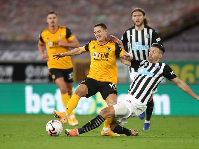 WOLVERHAMPTON, ENGLAND - OCTOBER 25: Daniel Podence of Wolverhampton Wanderers is tackled by Fabian Schar of Newcastle United during the Premier League match between Wolverhampton Wanderers and Newcastle United at Molineux on October 25, 2020 in Wolverhampton, England. Sporting stadiums around the UK remain under strict restrictions due to the Coronavirus Pandemic as Government social distancing laws prohibit fans inside venues resulting in games being played behind closed doors. (Photo by Nick Potts - Pool/Getty Images)