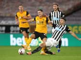 WOLVERHAMPTON, ENGLAND - OCTOBER 25: Daniel Podence of Wolverhampton Wanderers is tackled by Fabian Schar of Newcastle United during the Premier League match between Wolverhampton Wanderers and Newcastle United at Molineux on October 25, 2020 in Wolverhampton, England. Sporting stadiums around the UK remain under strict restrictions due to the Coronavirus Pandemic as Government social distancing laws prohibit fans inside venues resulting in games being played behind closed doors. (Photo by Nick Potts - Pool/Getty Images)
