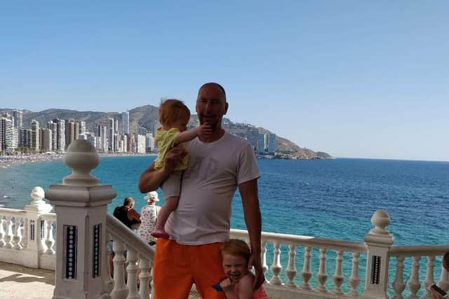 Lee Foster and his daughters pictured on holiday.